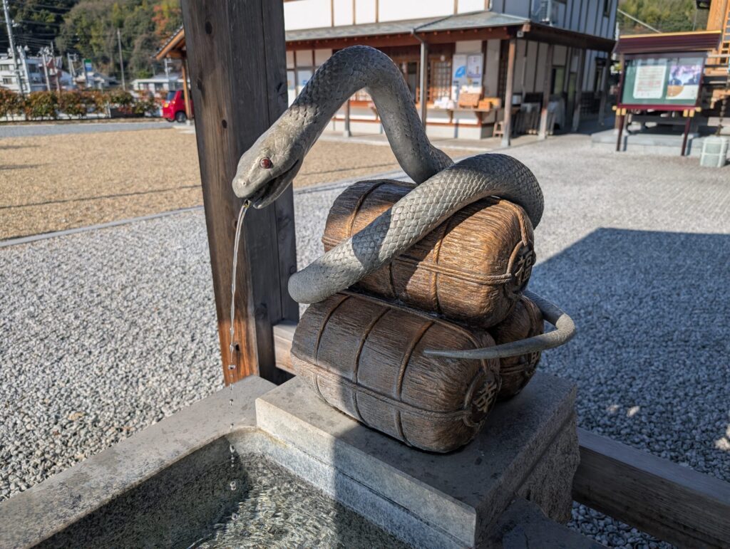 White snake water basin at Iwakuni White Snake Shrine, symbol of good fortune in Japan